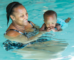 Parent Guiding Her Child While Swimming